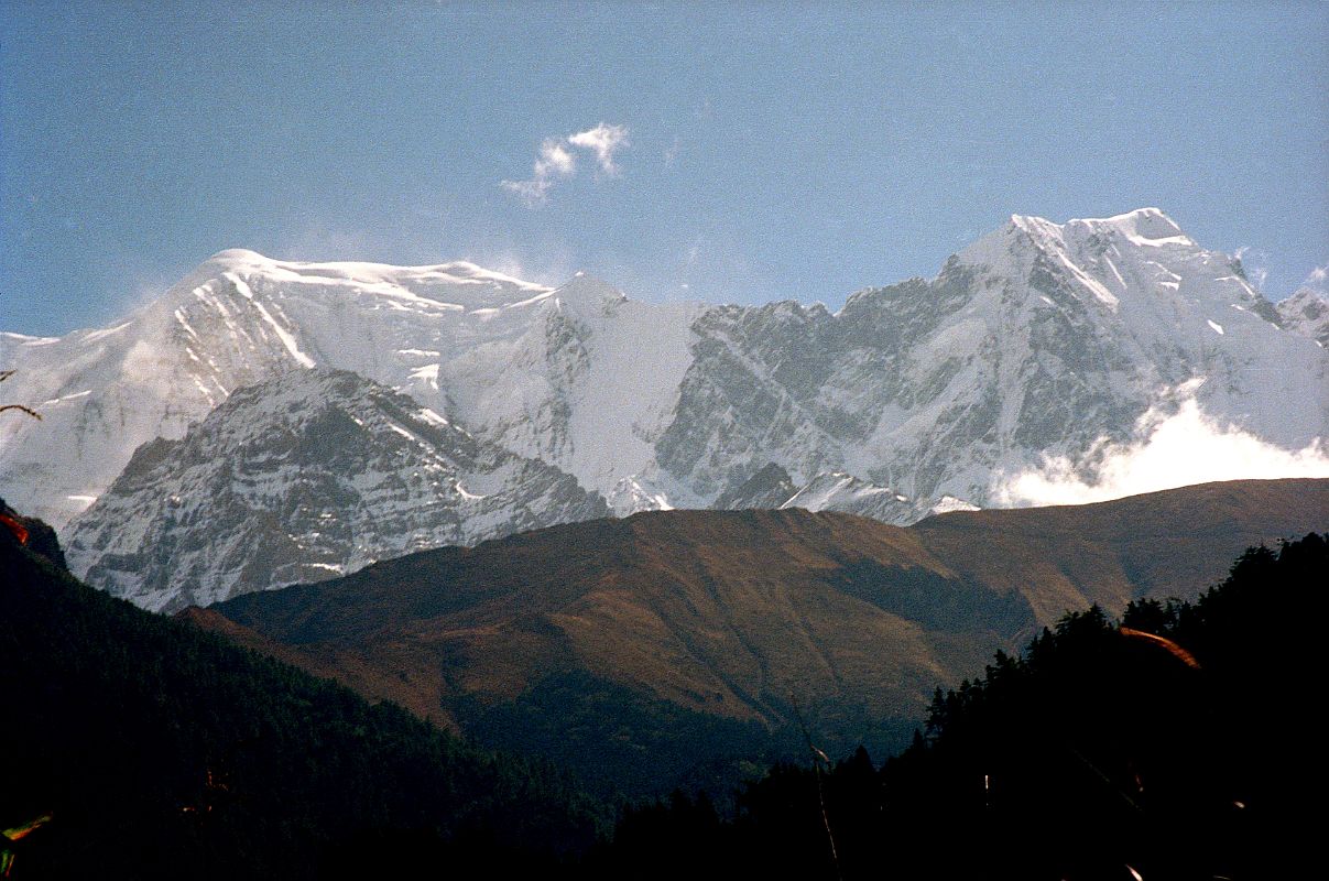 307 Nilgiri Central and Nilgiri South Close Up From Larjung Across the valley from Larjung I had a bright sun-in-your-face view of the west face of the Nilgiri peaks, with Nilgiri Central (6940m) and Nilgiri South (6839m) visible. 